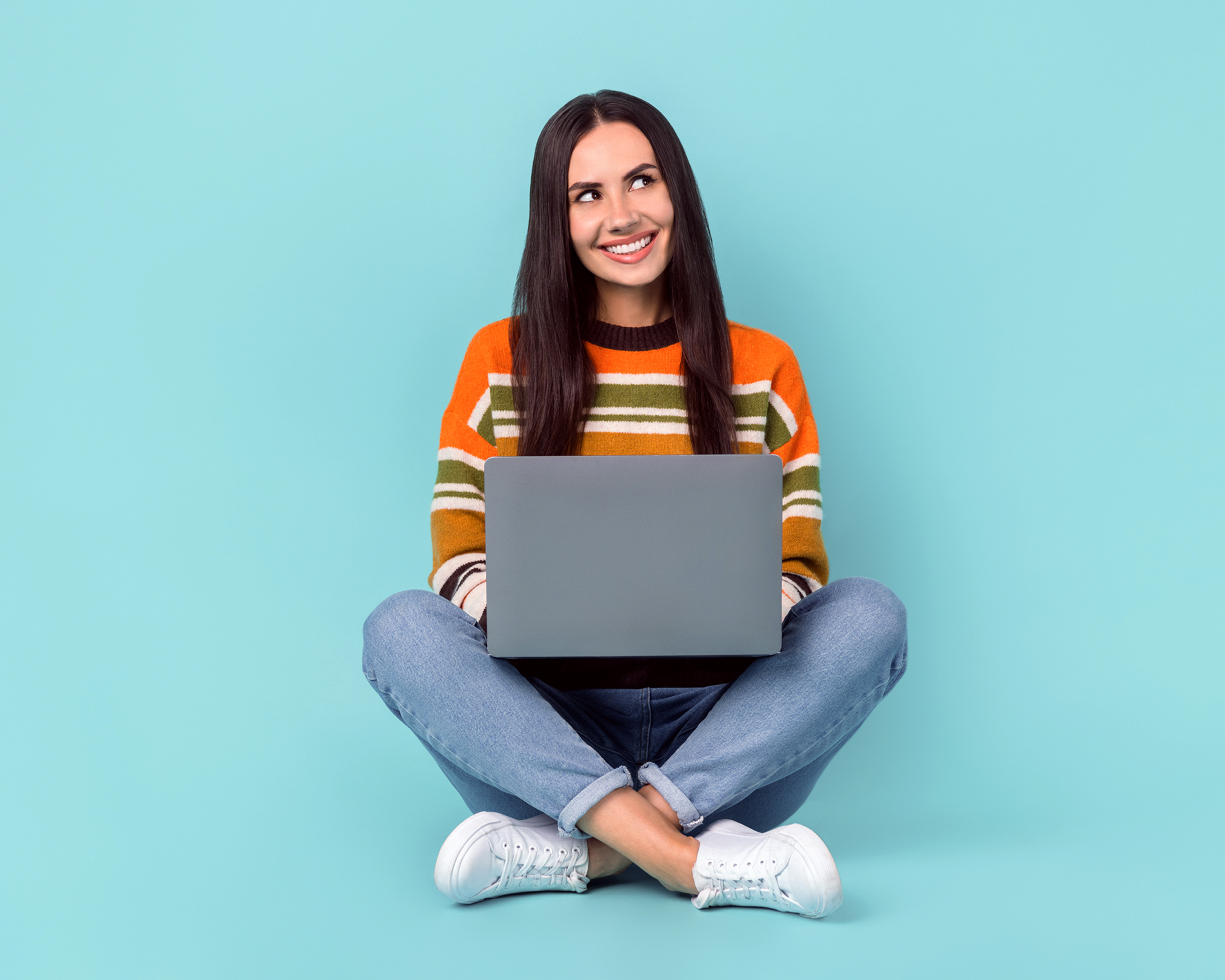 Female smiling and sitting with laptop 